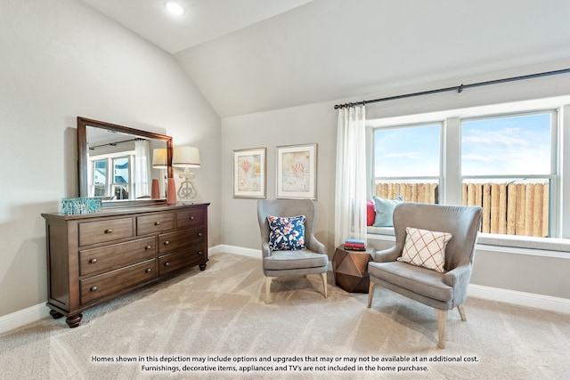 sitting room with lofted ceiling and light colored carpet