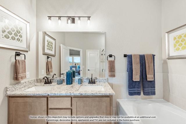 bathroom with a washtub and vanity