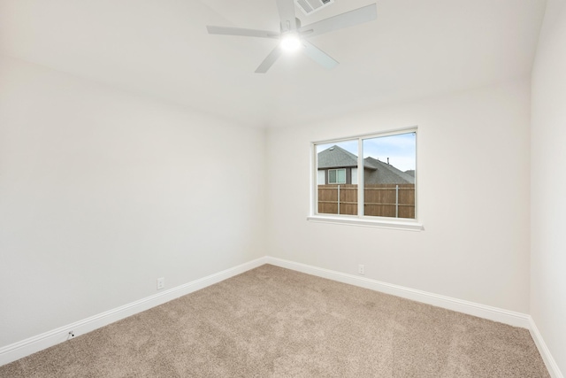 spare room with visible vents, baseboards, a ceiling fan, and carpet