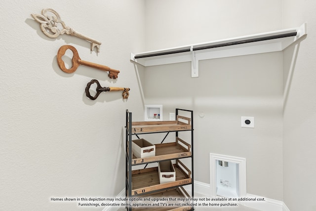 clothes washing area with gas dryer hookup, washer hookup, wood-type flooring, and electric dryer hookup