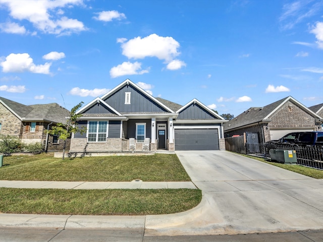 craftsman house with a garage and a front lawn