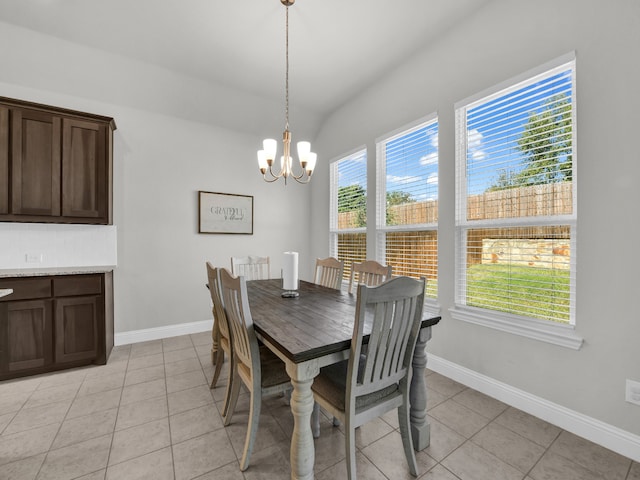 tiled dining area with a chandelier