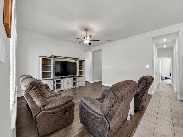 tiled living room with ceiling fan