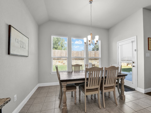 tiled dining room with an inviting chandelier and vaulted ceiling