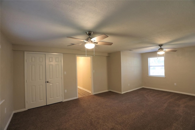 carpeted empty room featuring ceiling fan and a textured ceiling