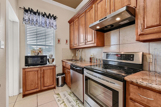 kitchen with ornamental molding, stainless steel appliances, light tile patterned floors, light stone countertops, and sink