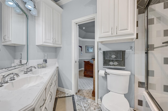 bathroom with toilet, vanity, tile patterned floors, and ornamental molding