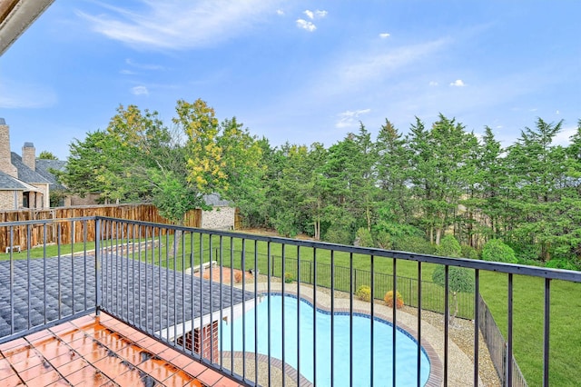 exterior space featuring a lawn and a fenced in pool