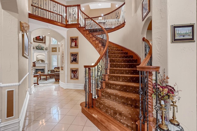 tiled foyer featuring a towering ceiling