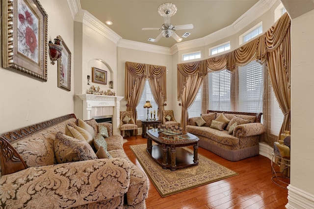 living room featuring ornamental molding, hardwood / wood-style flooring, and ceiling fan