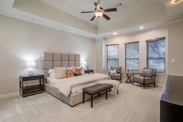 carpeted bedroom featuring a raised ceiling, ceiling fan, and crown molding