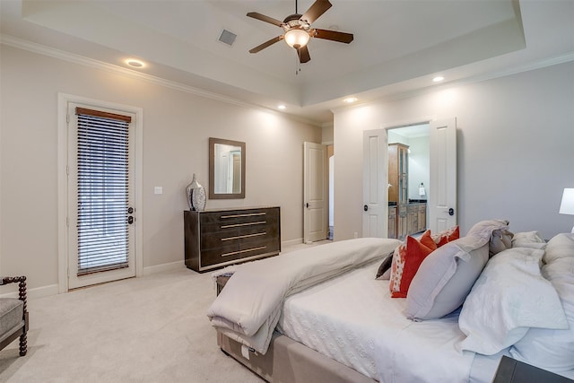 carpeted bedroom with ceiling fan, a raised ceiling, and ornamental molding