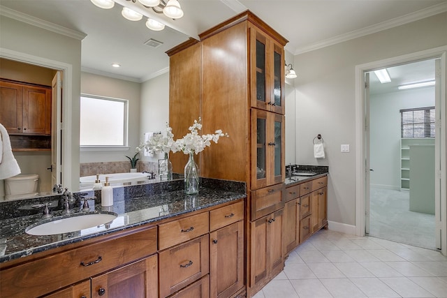 bathroom featuring ornamental molding, vanity, a tub to relax in, and tile patterned floors