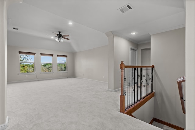 carpeted spare room with ceiling fan and crown molding