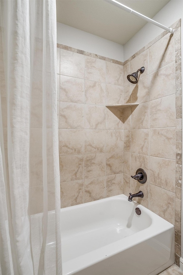 bathroom with shower / tub combo with curtain