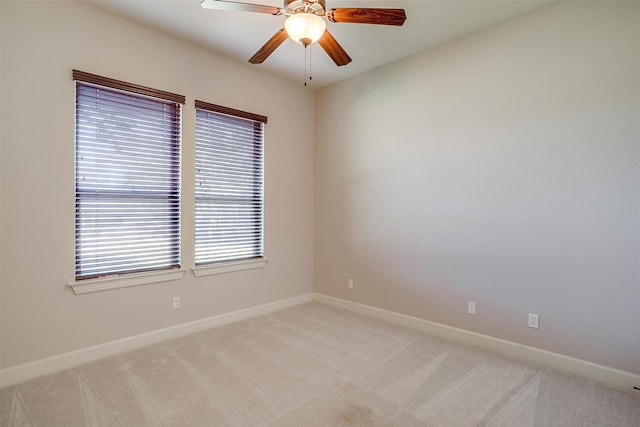 carpeted spare room with ceiling fan