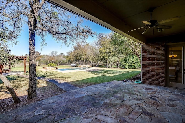 view of patio / terrace with a swimming pool with hot tub and ceiling fan