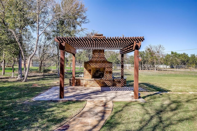 view of yard featuring an outdoor stone fireplace and a patio area