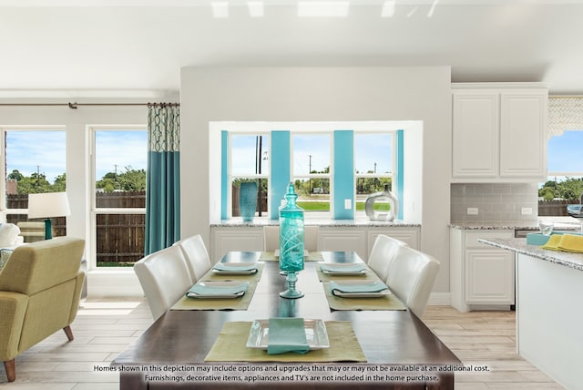 dining space with a wealth of natural light and light hardwood / wood-style floors