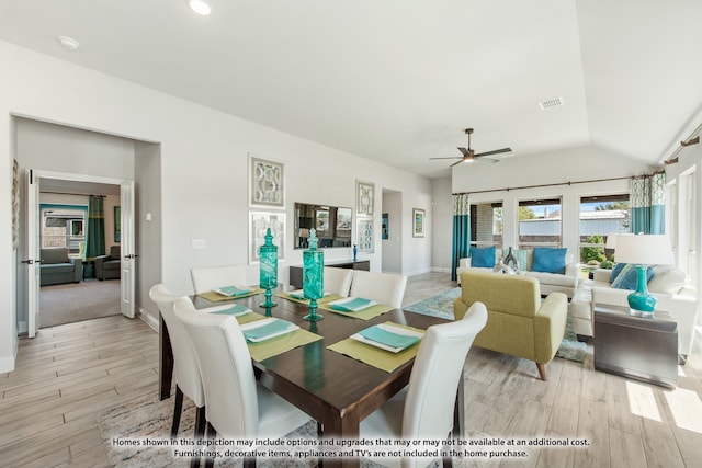 dining area featuring light wood-type flooring, lofted ceiling, and ceiling fan