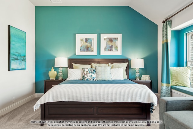 bedroom with lofted ceiling and light carpet