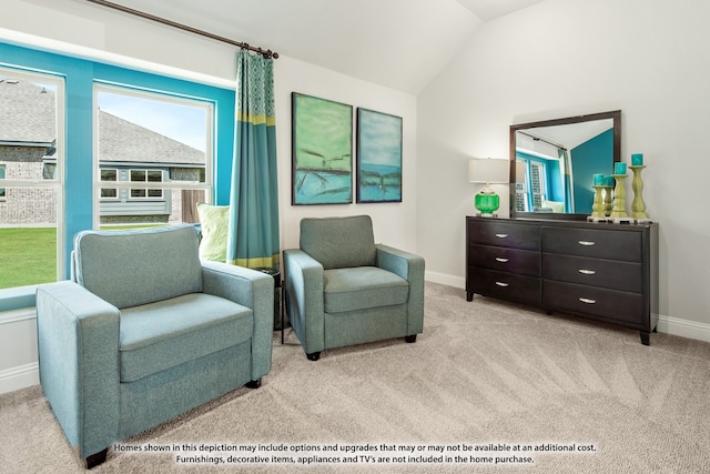 living area featuring light colored carpet and vaulted ceiling