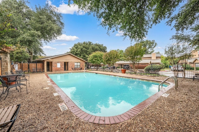 view of swimming pool with an outbuilding