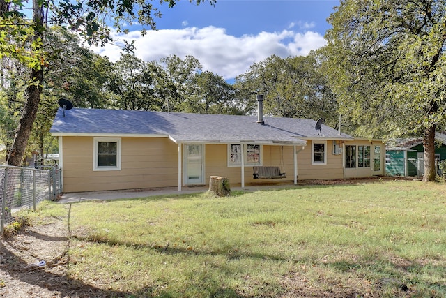 back of house featuring a lawn