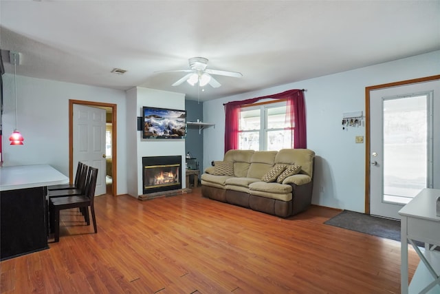 living room featuring hardwood / wood-style flooring and ceiling fan