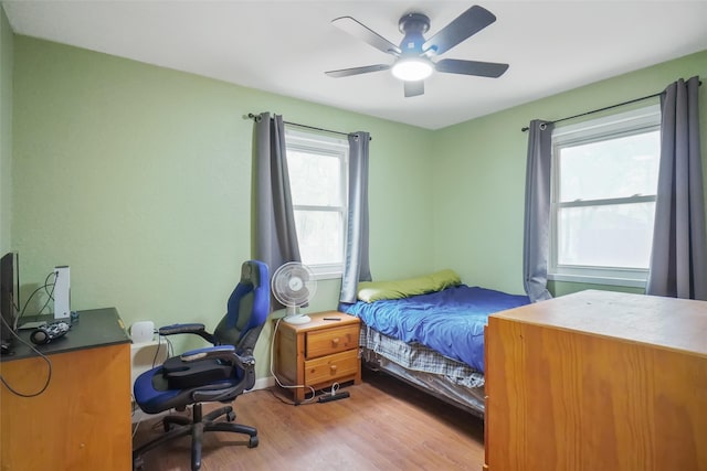 bedroom with light wood-type flooring and ceiling fan