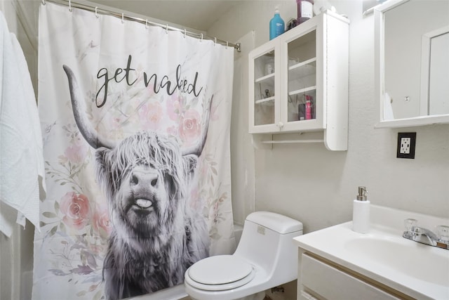 bathroom featuring vanity, toilet, and a shower with shower curtain