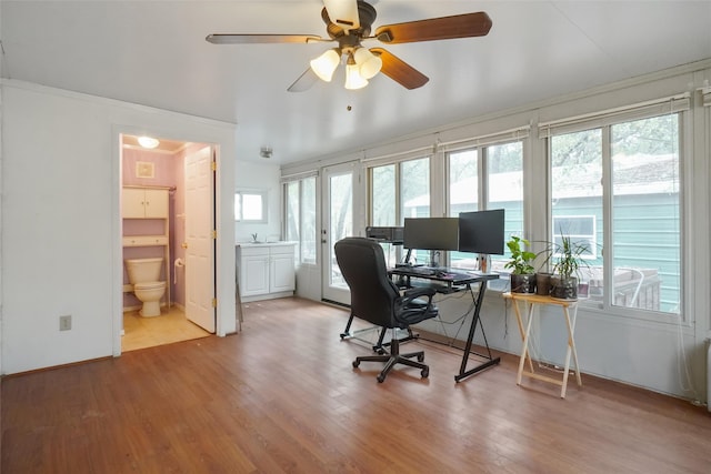 office with ornamental molding, light hardwood / wood-style flooring, ceiling fan, and plenty of natural light