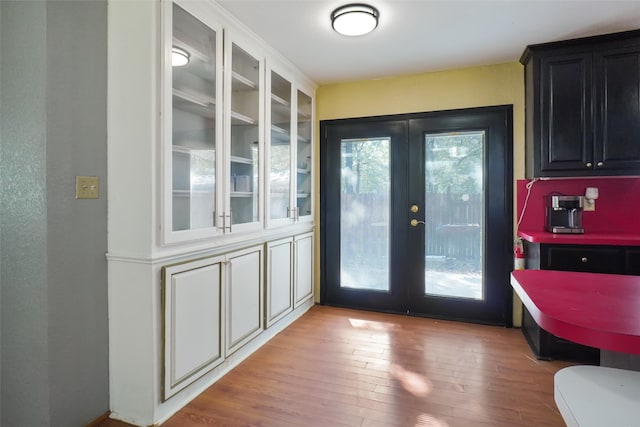 doorway to outside featuring french doors and light hardwood / wood-style floors