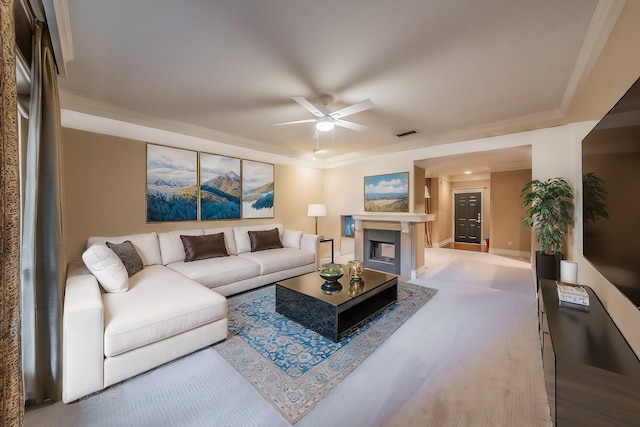 living room featuring ceiling fan and crown molding