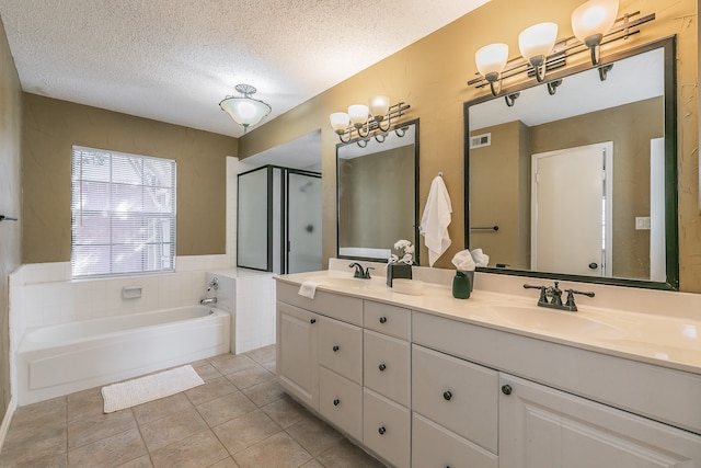 bathroom featuring vanity, a textured ceiling, tile patterned floors, and separate shower and tub