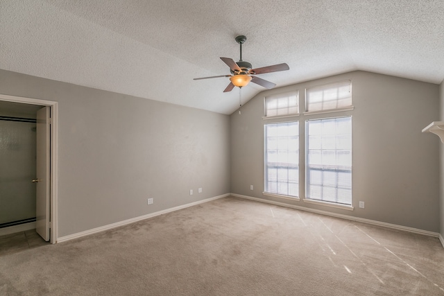 interior space with ceiling fan, a textured ceiling, and vaulted ceiling