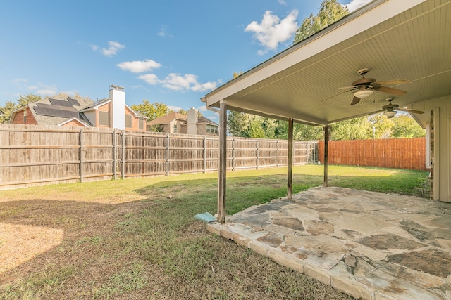 view of yard with a patio area and ceiling fan