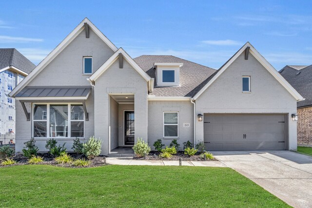 view of front of property with a garage and a front lawn