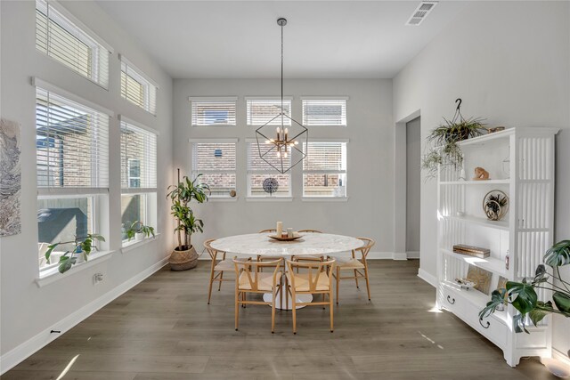 dining area featuring dark wood-type flooring and a wealth of natural light