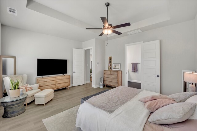 bedroom with ceiling fan and light wood-type flooring