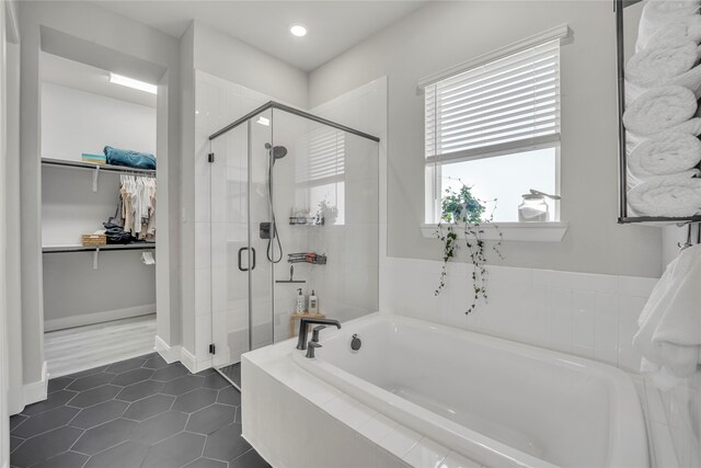 bathroom featuring tile patterned flooring and plus walk in shower