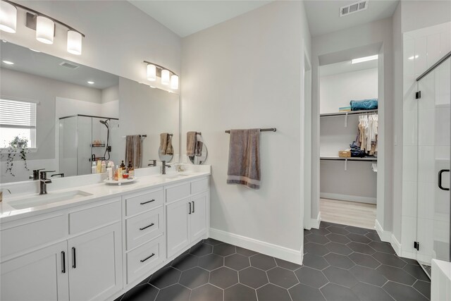 bathroom with vanity, tile patterned floors, and a shower with shower door