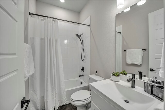 full bathroom with toilet, vanity, and shower / bath combo with shower curtain