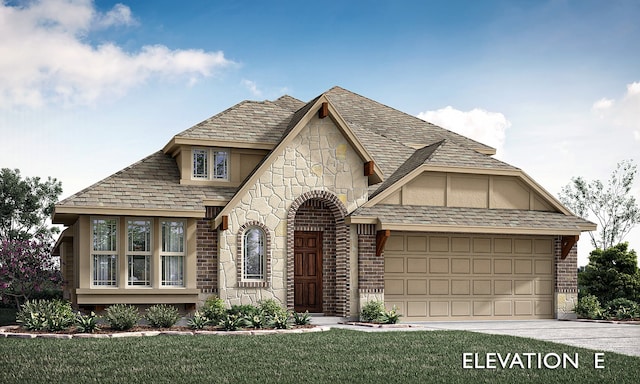 tudor home with a garage and a front lawn