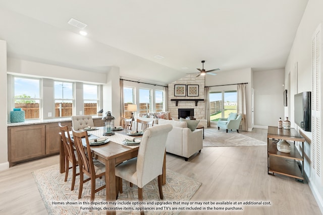 dining space featuring light wood-type flooring, a wealth of natural light, and vaulted ceiling