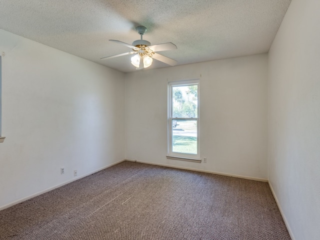 carpeted empty room featuring a textured ceiling and ceiling fan