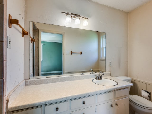 bathroom featuring vanity, toilet, and a textured ceiling