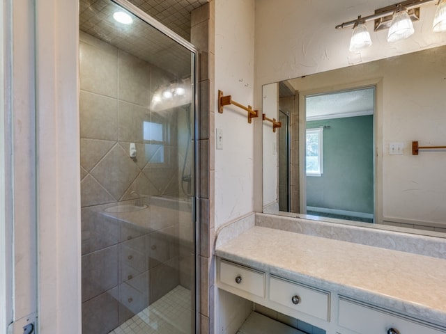 bathroom with vanity and a shower with door