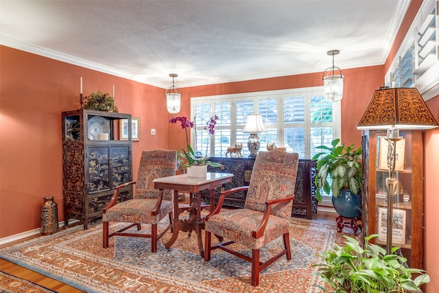 dining space featuring a textured ceiling, a chandelier, hardwood / wood-style floors, and crown molding