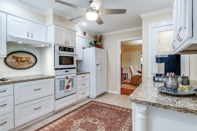 kitchen featuring light stone counters, decorative backsplash, ornamental molding, white cabinetry, and white appliances